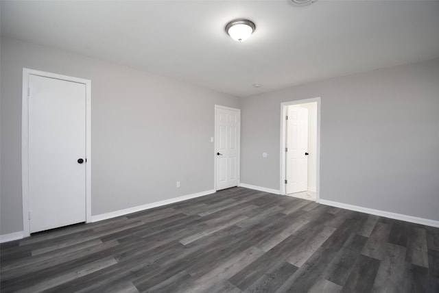 unfurnished room featuring dark wood-type flooring