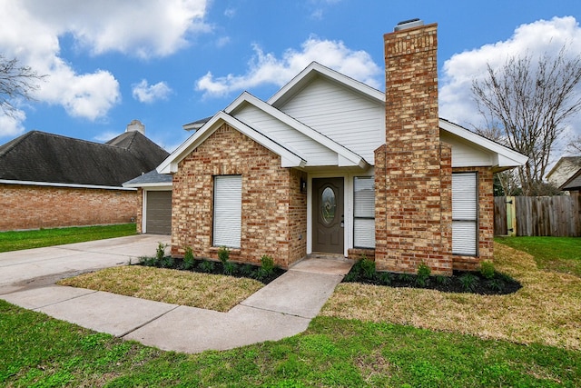 view of front of home with a garage and a front lawn