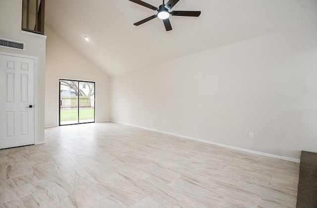 empty room with ceiling fan and high vaulted ceiling