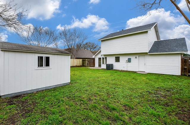 view of yard featuring central AC and an outdoor structure