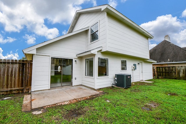 rear view of property with central AC, a yard, and a patio