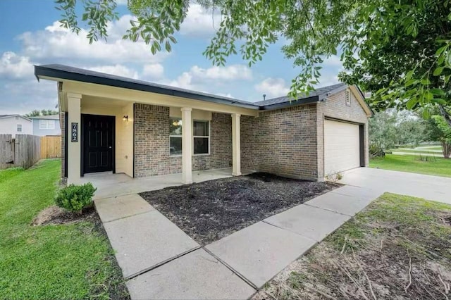 ranch-style house featuring a garage and a front yard