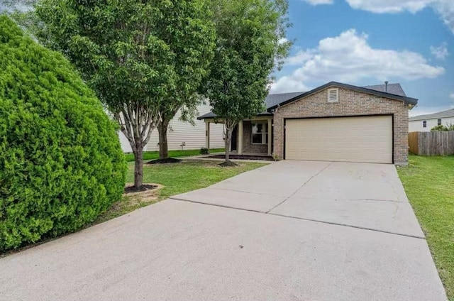 view of front of house featuring a garage and a front lawn