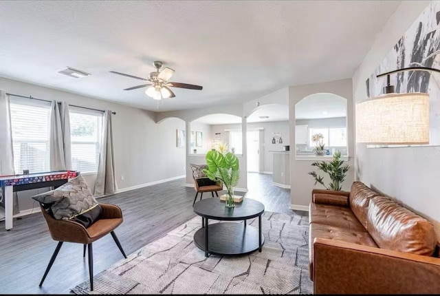 living room with hardwood / wood-style floors and ceiling fan