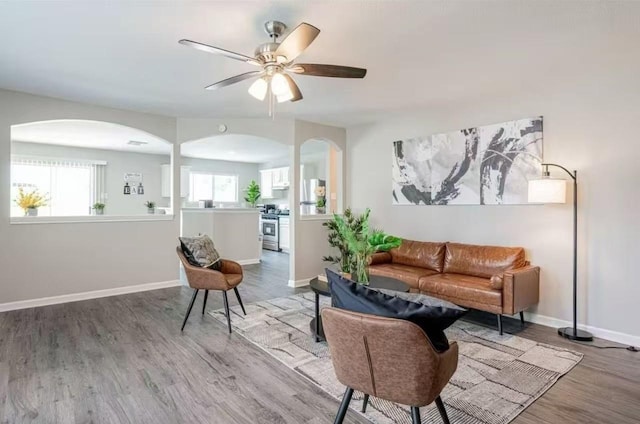 living room featuring hardwood / wood-style floors and ceiling fan