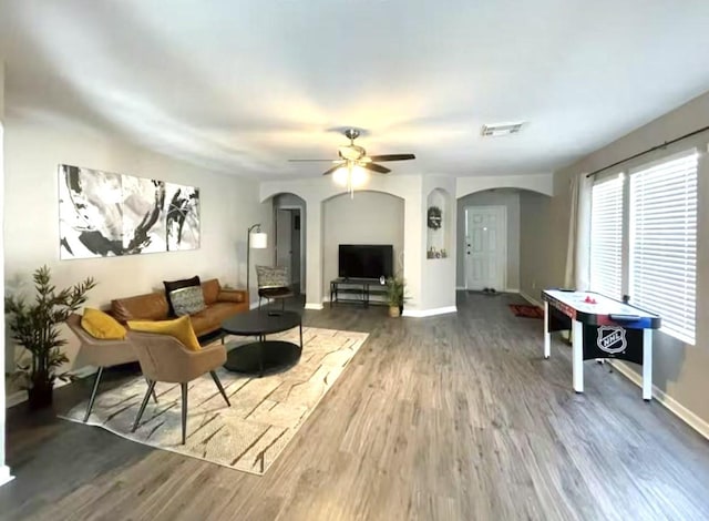 living room with ceiling fan and wood-type flooring