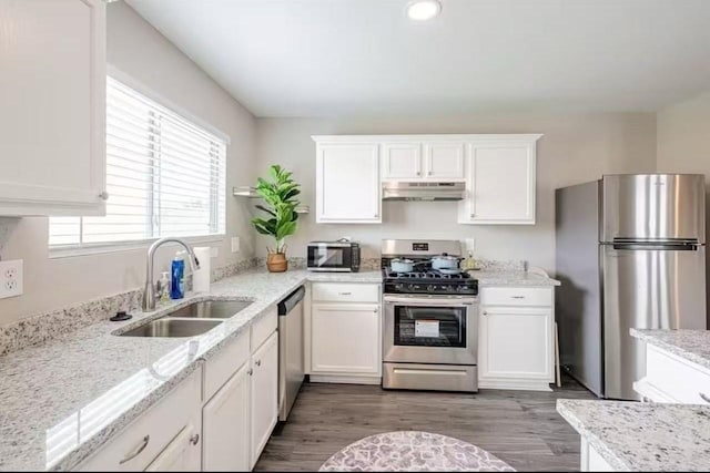 kitchen featuring dark hardwood / wood-style floors, sink, white cabinets, stainless steel appliances, and light stone countertops