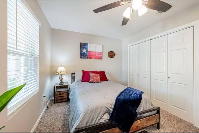 carpeted bedroom featuring ceiling fan and a closet