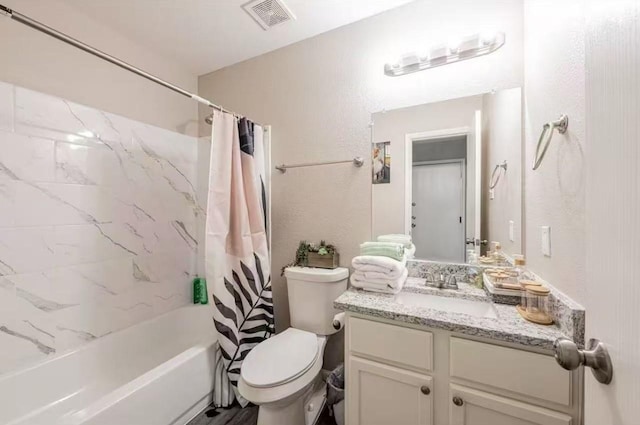 full bathroom with vanity, shower / bath combination with curtain, and toilet