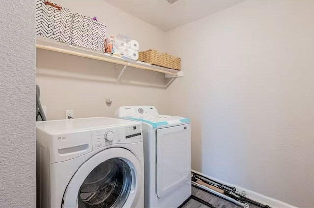 clothes washing area featuring washer and clothes dryer