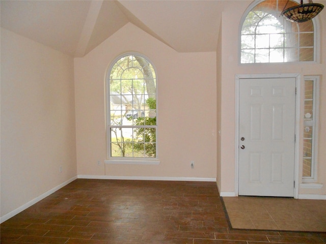 entrance foyer featuring vaulted ceiling and dark hardwood / wood-style flooring