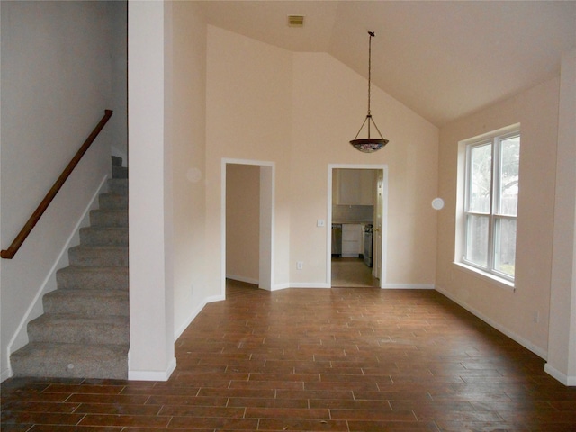 unfurnished room featuring high vaulted ceiling and dark hardwood / wood-style floors