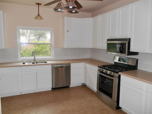 kitchen featuring appliances with stainless steel finishes, ceiling fan, pendant lighting, sink, and white cabinetry