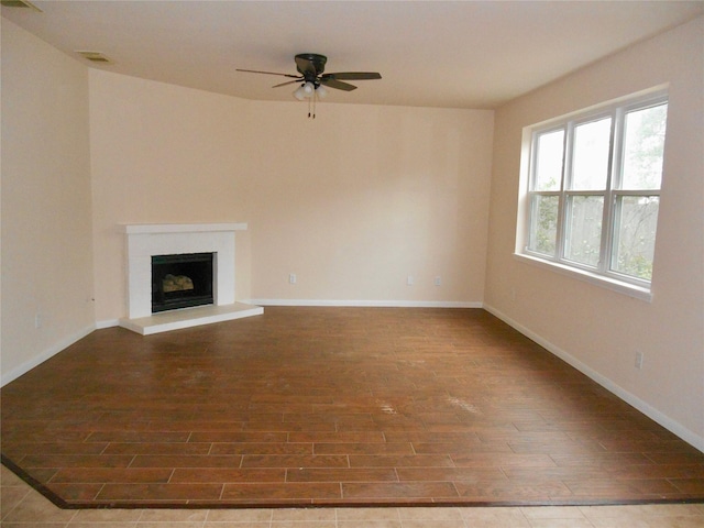 unfurnished living room with ceiling fan and wood-type flooring