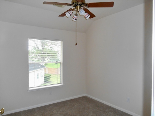 carpeted empty room featuring vaulted ceiling and ceiling fan