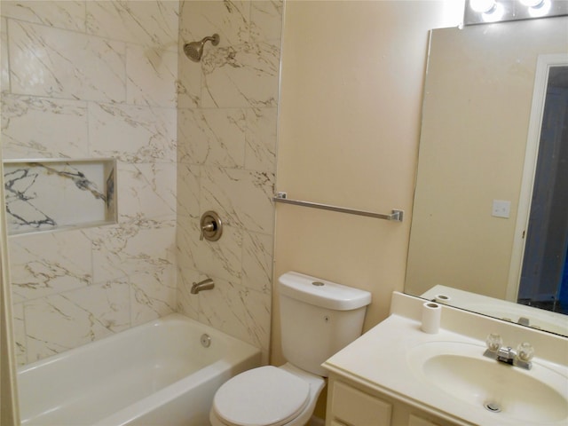 full bathroom with vanity, tiled shower / bath, and toilet