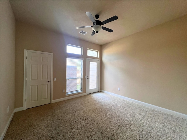 carpeted empty room featuring ceiling fan