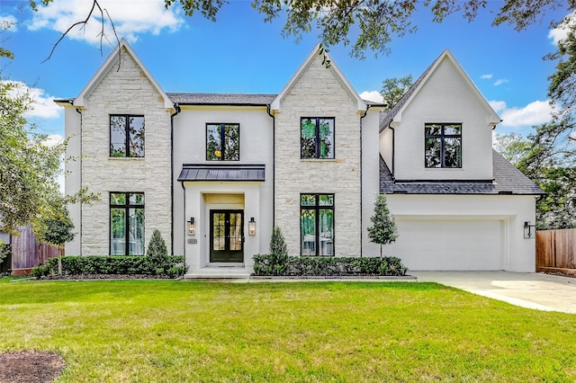 view of front of house with a garage, a front lawn, and french doors