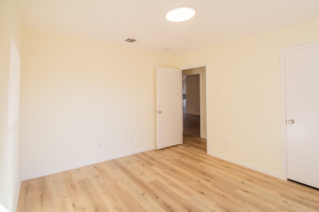 empty room with light hardwood / wood-style flooring