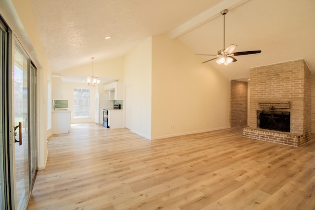 unfurnished living room featuring beamed ceiling, light wood-type flooring, a textured ceiling, and a fireplace