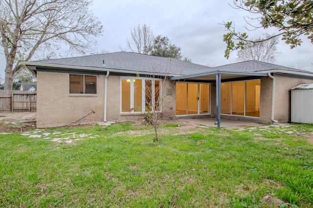 rear view of house with a lawn