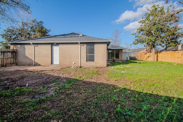 back of property featuring a yard