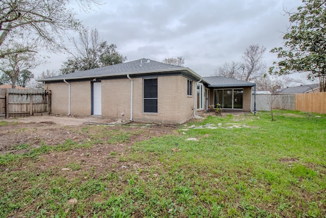 back of house with a yard