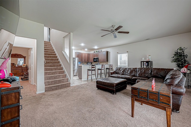 living room with light carpet and ceiling fan