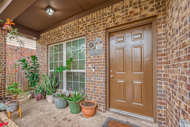 view of exterior entry with a porch