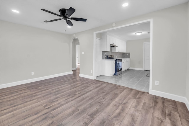 unfurnished living room featuring light hardwood / wood-style flooring and ceiling fan