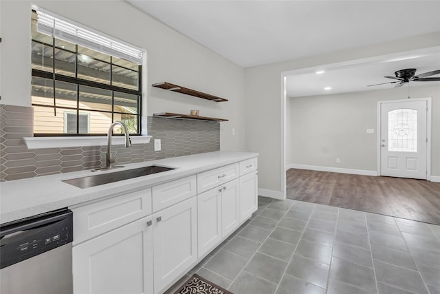 kitchen with white cabinets, plenty of natural light, sink, and dishwasher