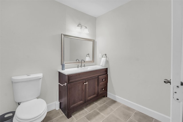 bathroom featuring vanity, tile patterned floors, and toilet