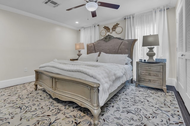 bedroom featuring ornamental molding, a closet, and ceiling fan