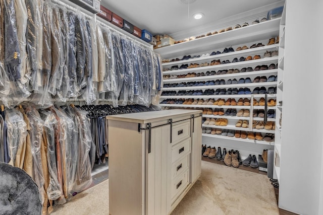 walk in closet featuring light colored carpet