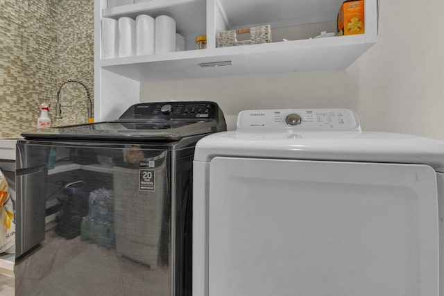 washroom with washer and dryer