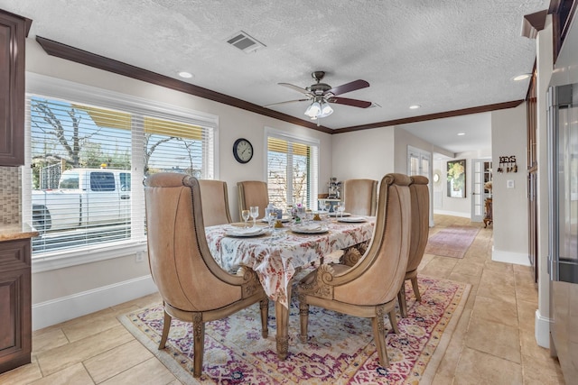 dining room featuring crown molding, ceiling fan, and a textured ceiling