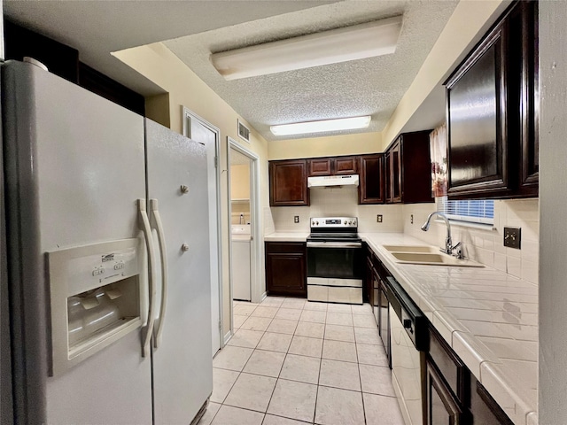 kitchen with electric stove, sink, black dishwasher, white refrigerator with ice dispenser, and tile counters