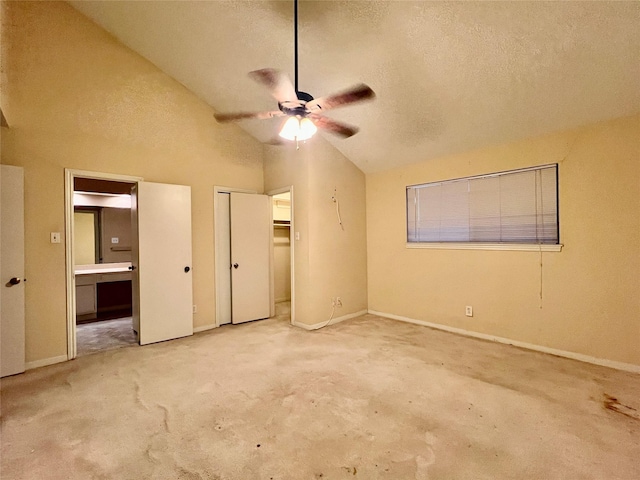 unfurnished bedroom with connected bathroom, lofted ceiling, ceiling fan, a textured ceiling, and a closet