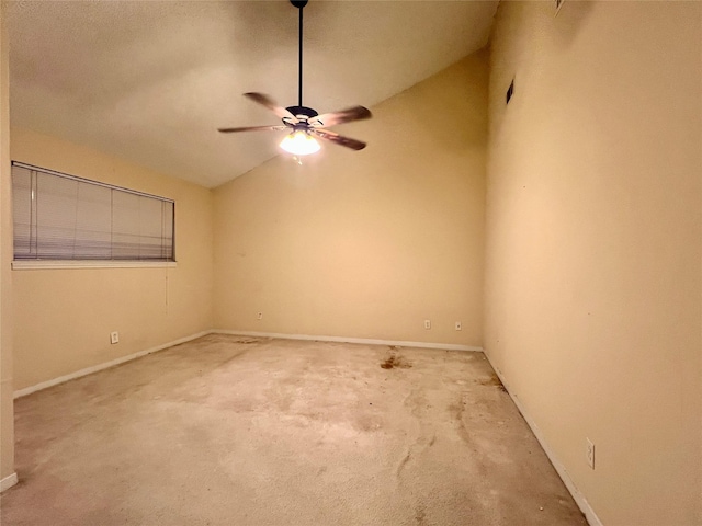 carpeted spare room featuring ceiling fan and vaulted ceiling