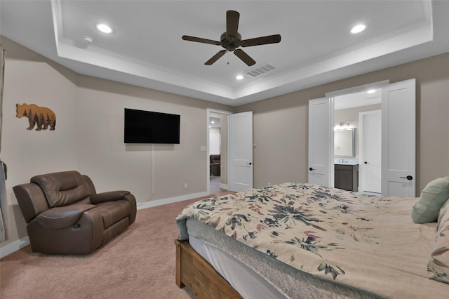 bedroom featuring crown molding, a tray ceiling, and carpet