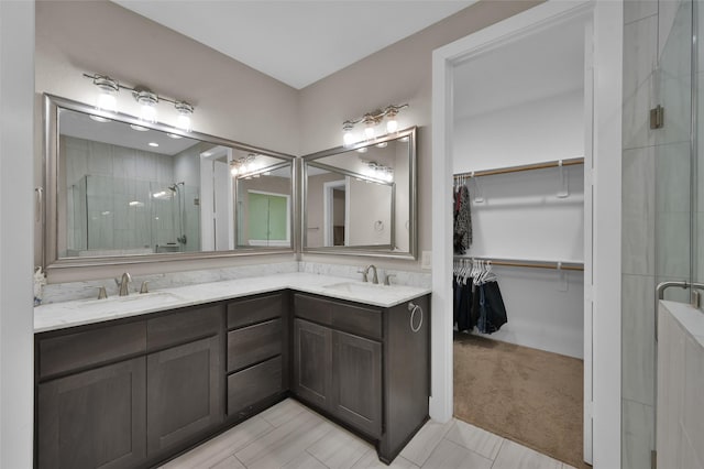 bathroom with vanity and a shower with shower door