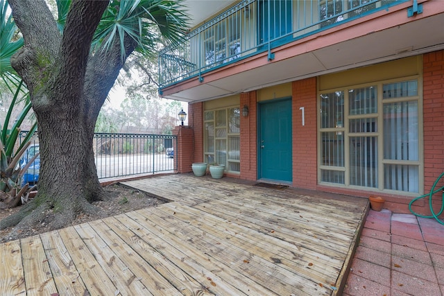 wooden terrace featuring a water view