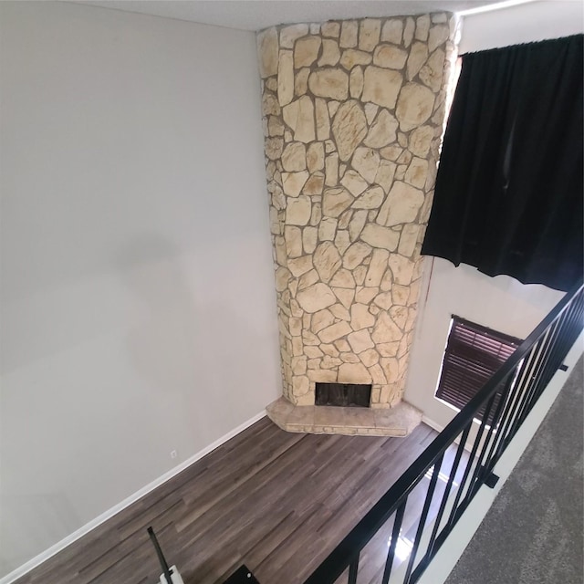 unfurnished living room featuring hardwood / wood-style flooring and a fireplace