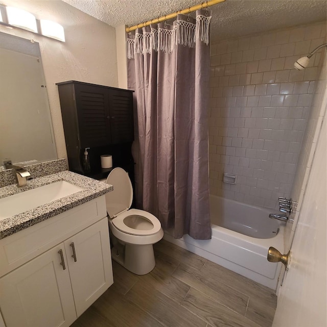 full bathroom featuring vanity, toilet, a textured ceiling, and shower / bath combo