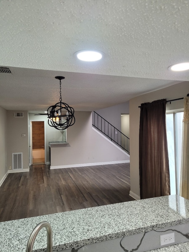 interior space featuring dark wood-type flooring and a textured ceiling