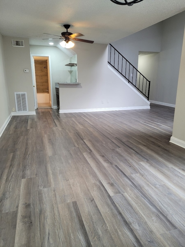 unfurnished living room featuring hardwood / wood-style floors, a textured ceiling, and ceiling fan