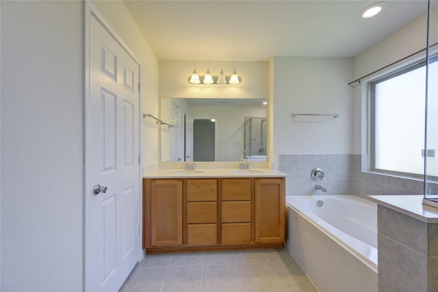 bathroom with tile patterned floors, shower with separate bathtub, and vanity