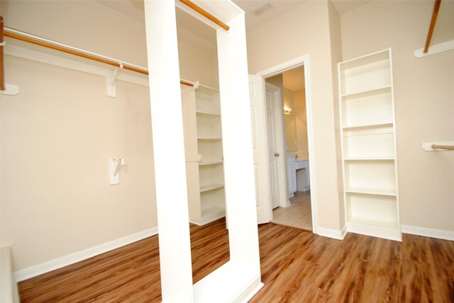 spacious closet featuring hardwood / wood-style floors