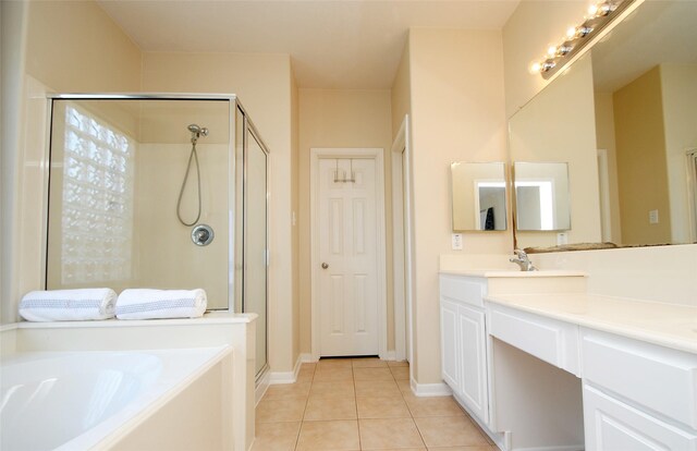 bathroom featuring tile patterned flooring, vanity, and separate shower and tub