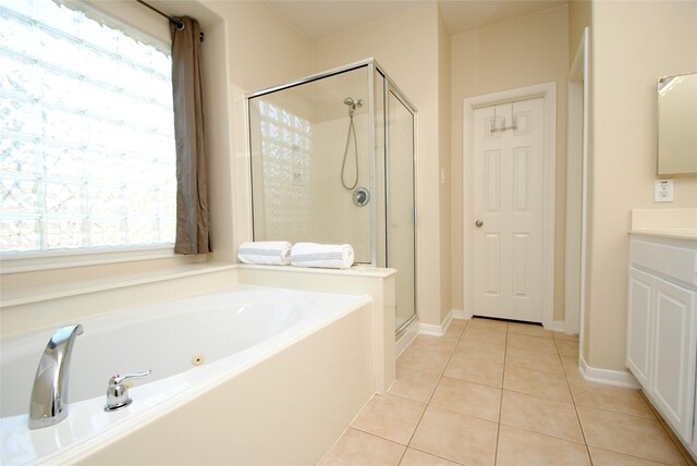 bathroom with tile patterned floors, plus walk in shower, and vanity